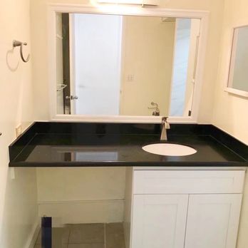 Kohola Construction - a bathroom with a sink and mirror - General Contractors Near Me Kohola Construction - a bathroom with a sink and mirror - General Contractors Near Me