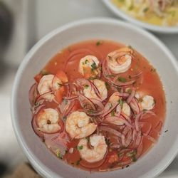 Andes Cafe - Shrimp Ceviche | ECUADOR Ecuadorian-style shrimp ceviche with tomato, red onion, lime, plantain chips & popcorn