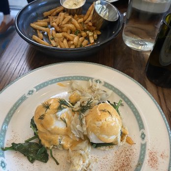 Copper Vine Inn - Crabcake eggs Benny with truffle fries, chicken sandwich and Brussels sprouts behind - Wine Bars Near Me - New Orleans, Louisiana Copper Vine Inn - Crabcake eggs Benny with truffle fries, chicken sandwich and Brussels sprouts behind - Wine Bars Near Me - New Orleans, Louisiana