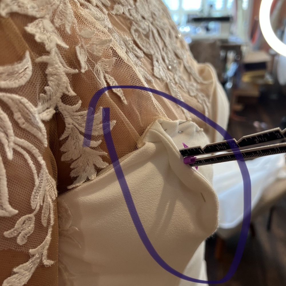 Hoda's Tailoring - This is the new seamstress measuring how much she has to take in due to the chest of the dress being too big - Bridal Near Me - Fredericksburg, Virginia Hoda's Tailoring - This is the new seamstress measuring how much she has to take in due to the chest of the dress being too big - Bridal Near Me - Fredericksburg, Virginia