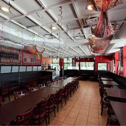A spacious dining area with comfortable seating, colorful traditional décor, and a warm atmosphere inspired by Lahore's culture.
