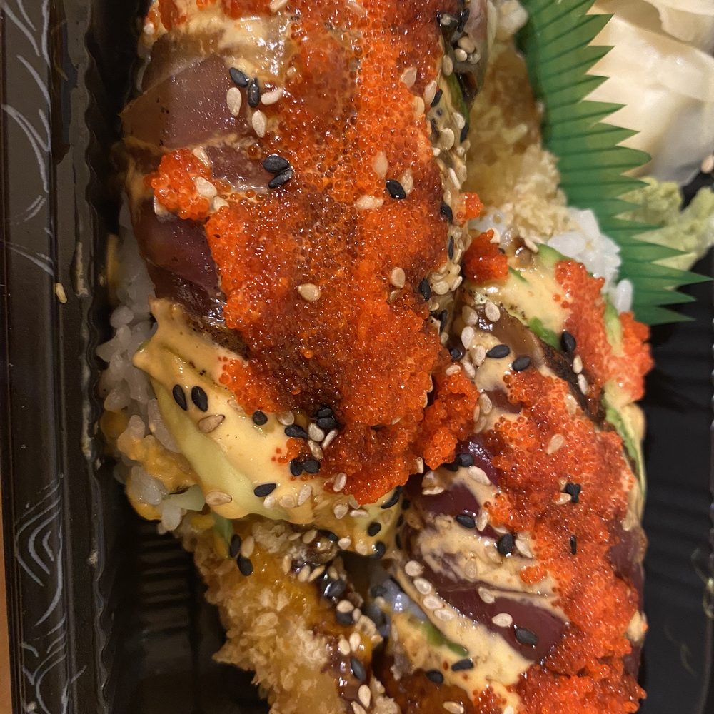 Flaming Dragon Roll - shrimp tempura inside and eel and another fish wrapped outside. Flaming Dragon Roll - shrimp tempura inside and eel and another fish wrapped outside.