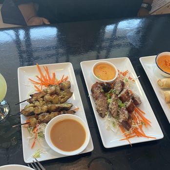 Niran's Kitchen - L to R: chicken satay, sai gok, crispy egg rolls - Laotian Near Me - Deerfield Beach, Florida Niran's Kitchen - L to R: chicken satay, sai gok, crispy egg rolls - Laotian Near Me - Deerfield Beach, Florida