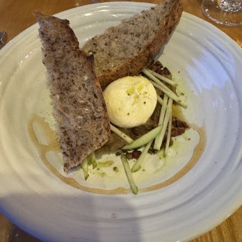 Simon Pearce - Maple Brook burrata with shaved asparagus, fennel agrodolce, mint, and charred five-grain sourdough loaf - New American Near Me - Quechee, Vermont