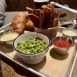 Fish & Chips - beer battered Cod, green peas, hand cut chips, tartar sauce and slice of lemon. Server brought ketchup for the fries. Fish & Chips - beer battered Cod, green peas, hand cut chips, tartar sauce and slice of lemon. Server brought ketchup for the fries.