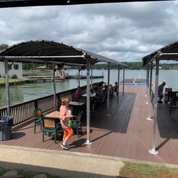 The Landing At Parker Creek - people sitting at tables on the dock - Bars Near Me - Equality, Alabama