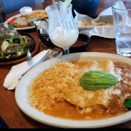 Shrimp enchiladas, piña colada and steak fajitas