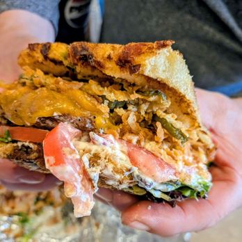 Chris' NY Sandwich Co - This is half of the jalapeno hamburger. Matt got a couple bites into it before I could take a photo. Really delicious! - Delis Near Me - Buffalo, New York
