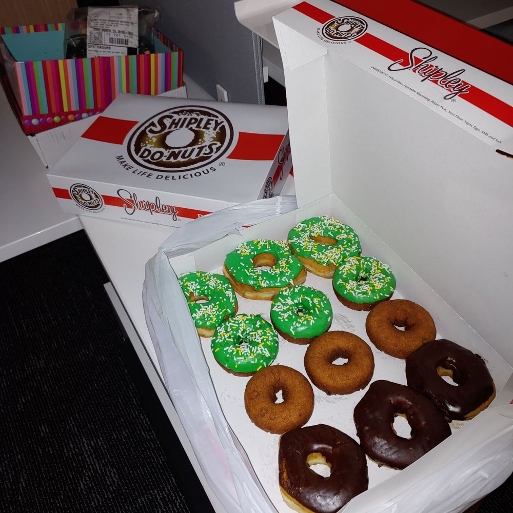Chocolate iced, green iced, and cake (plain and iced) donut with kolaches in closed box. Chocolate iced, green iced, and cake (plain and iced) donut with kolaches in closed box.
