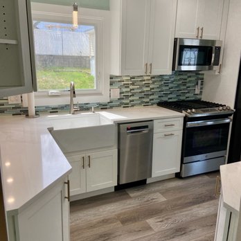 M&K Contracting - a kitchen with white cabinets and stainless steel appliances - General Contractors Near Me M&K Contracting - a kitchen with white cabinets and stainless steel appliances - General Contractors Near Me