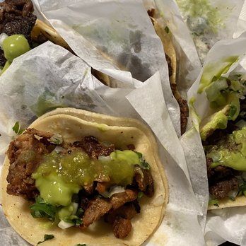 Taquero's - three tacos on a checkered table cloth - Food Trucks Near Me