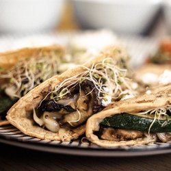 Taco House - Vegetarian tacos. Portobello Mushroom, eggplant and zucchini all melted with cheese and topped with fresh vegetables.