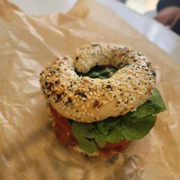 a bagel sandwich with lettuce and tomato a bagel sandwich with lettuce and tomato