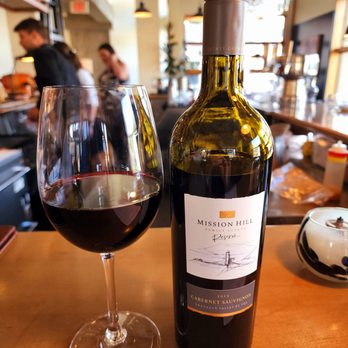 The Bison Restaurant - a bottle of wine and a glass of wine - Canadian (New) Near Me - Banff, Alberta The Bison Restaurant - a bottle of wine and a glass of wine - Canadian (New) Near Me - Banff, Alberta