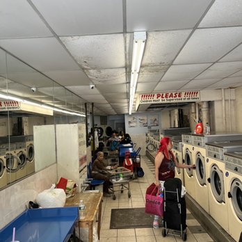 Alpine Cleaners & Laundromat - Patrons doing laundry in coin operated machines. - Laundry Services Near Me - New York, New York Alpine Cleaners & Laundromat - Patrons doing laundry in coin operated machines. - Laundry Services Near Me - New York, New York