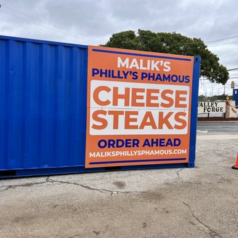 Malik's Philly's Phamous Cheesesteaks - a sign in front of a blue shipping container - Food Trucks Near Me - Universal City, Texas Malik's Philly's Phamous Cheesesteaks - a sign in front of a blue shipping container - Food Trucks Near Me - Universal City, Texas
