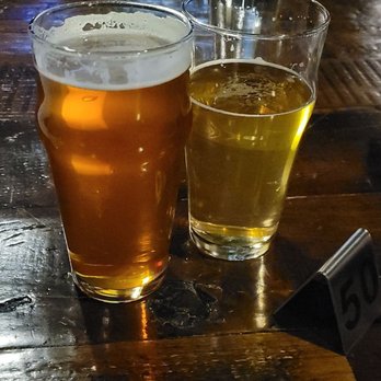 Downtown Underground - a beer and a beer glass on a wooden table - Comedy Clubs Near Me - Mesa, Arizona