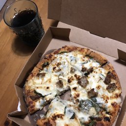 A spinach feta pizza and the meatza pizza