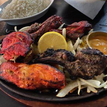 Prime Bar and Grill - Mixed grill: Tandoori chicken, salmon, lamb and a shrimp over onions, peppers and carrots. - Indian Near Me - Tehachapi, California Prime Bar and Grill - Mixed grill: Tandoori chicken, salmon, lamb and a shrimp over onions, peppers and carrots. - Indian Near Me - Tehachapi, California