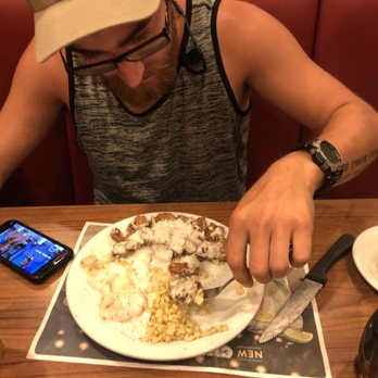 Denny's - a man sitting at a table with a plate of food - Diners Near Me - New Port Richey, Florida Denny's - a man sitting at a table with a plate of food - Diners Near Me - New Port Richey, Florida