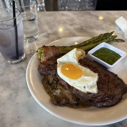 Fire roasted ribeye with a mushroom cream sauce. Drinking a Purple Rain. Vodka, lavender syrup, lemon juice, and blueberries. Fire roasted ribeye with a mushroom cream sauce. Drinking a Purple Rain. Vodka, lavender syrup, lemon juice, and blueberries.