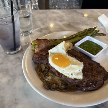 Tapa Rio - Fire roasted ribeye with a mushroom cream sauce. Drinking a Purple Rain. Vodka, lavender syrup, lemon juice, and blueberries. - Tapas/Small Plates Near Me - Fredericksburg, Virginia Tapa Rio - Fire roasted ribeye with a mushroom cream sauce. Drinking a Purple Rain. Vodka, lavender syrup, lemon juice, and blueberries. - Tapas/Small Plates Near Me - Fredericksburg, Virginia