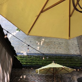 Chandler's - a patio with a yellow umbrella - New American Near Me - Petoskey, Michigan