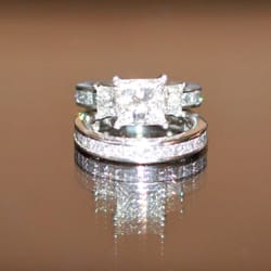 Neil Dahl Jewelers Of California - custom made: platinum channel set princess cut 3/4 eternity bands, side stones .53 carats, center stone - use ur imagination ;)