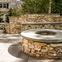 Highlands Landscape Construction - New blue stone patio and fire pit with South Bay stone walls, for a client in Wellesley, MA