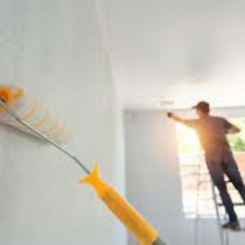 Delta Construction - a man on a ladder painting a wall - General Contractors Near Me Delta Construction - a man on a ladder painting a wall - General Contractors Near Me