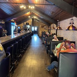 Main seating area is the row of booths at right. At left is the bar
