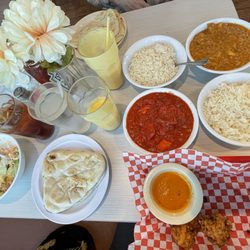 Dino Buffet and Bar - Full spread! Vegetable Pakoras & Chutney app. Chicken Tikka Masala, Butter Chicken, Basmati Rice & Salad. 2 orders of Naan & a Mango Lassi
