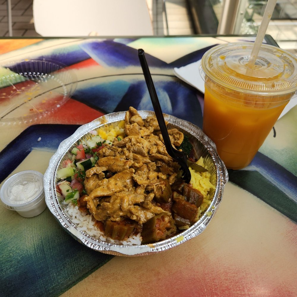 Half and half white rice and yellow rice, shawarma, okra, corn, veggies, side of garlic sauce, and mango drink with ice. Half and half white rice and yellow rice, shawarma, okra, corn, veggies, side of garlic sauce, and mango drink with ice.