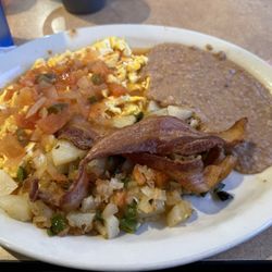 Huevos rancheros soft scrambled, papas ala Mexicano, bacon and beans and coffee! Good food!