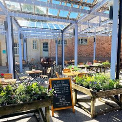 The Stables Restaurant - Peaceful outdoor seating in our Courtyard is available, surrounded by plants and warmed by a cozy firepit in the winter months.