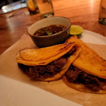El Vez - Birria tacos- Chile braised beef, queso mixto, consommé, cilantro & onion. ($20) Fine. Tortilla could be better. - Mexican Near Me - New York, New York El Vez - Birria tacos- Chile braised beef, queso mixto, consommé, cilantro & onion. ($20) Fine. Tortilla could be better. - Mexican Near Me - New York, New York