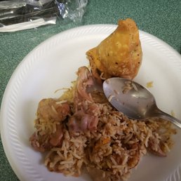As shown in the photo is the rice and chicken, with a bone on top that was hidden between the rice. As shown in the photo is the rice and chicken, with a bone on top that was hidden between the rice.