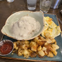 Biscuits and turkey sausage gravy with home fries and scrambled eggs with cheddar cheese