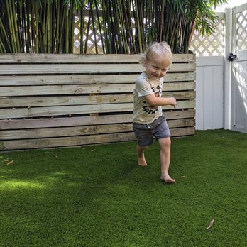 Greenworks Artificial Grass - Happy kiddo! Look at how nice that turf compresses under foot. Better than regular grass! - Artificial Turf Near Me Greenworks Artificial Grass - Happy kiddo! Look at how nice that turf compresses under foot. Better than regular grass! - Artificial Turf Near Me