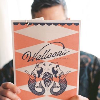 Walloon's Restaurant - a man holding up a menu - Seafood Near Me - Fort Worth, Texas Walloon's Restaurant - a man holding up a menu - Seafood Near Me - Fort Worth, Texas
