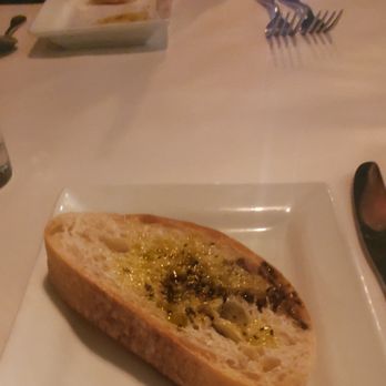 Zinicola - Slice of bread with olive oil dip - Italian Near Me - Charlotte, North Carolina Zinicola - Slice of bread with olive oil dip - Italian Near Me - Charlotte, North Carolina
