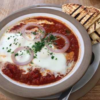 HoMA Cafe - Shakshouka (Moroccan eggs): Two eggs baked in a seasoned tomato sauce and served with pita bread - Sandwiches Near Me - Honolulu, Hawaii HoMA Cafe - Shakshouka (Moroccan eggs): Two eggs baked in a seasoned tomato sauce and served with pita bread - Sandwiches Near Me - Honolulu, Hawaii
