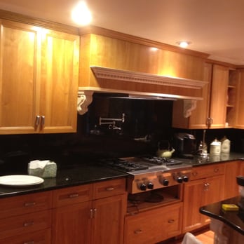 Moraes Remodeling - a kitchen with wood cabinets - General Contractors Near Me - Newton, Massachusetts