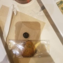 Tiny burned cookie with a blueberry (to show actual size).