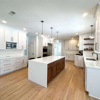 DBS Remodel - The white cabinets pair perfectly with the walnut island. Just look at that waterfall countertop! - General Contractors Near Me - Poughkeepsie, New York