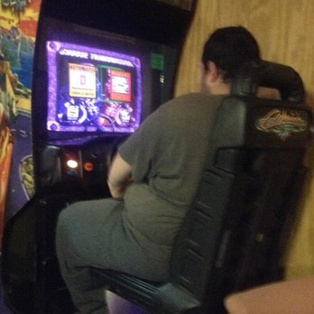 Adams Bowl - My cousin playing a racing arcade game. - Bowling Near Me - Centerville, Iowa