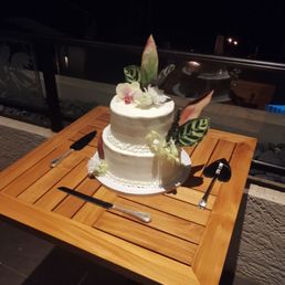 a wedding cake on a wooden table