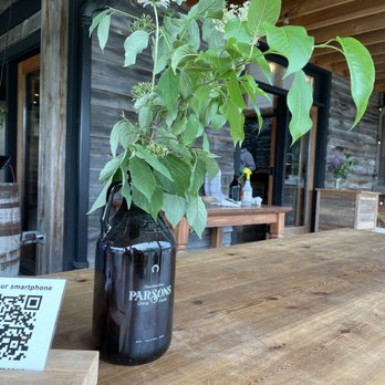 Parson's Brewing - a beer bottle with a plant in it - Breweries Near Me - Picton, Ontario