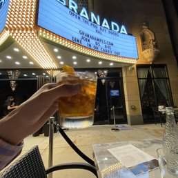 My adult beverage and the Granada marquee from our patio table.