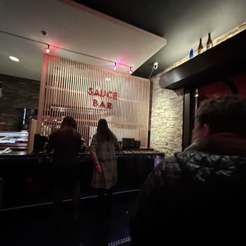 Sushi Motto - people standing at a bar - Japanese Near Me - Anchorage, Alaska